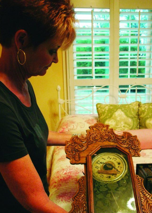 Sheila Spiceland holds up one of the antique clocks burglars destroyed Sunday evening. || Brian Barron/The News