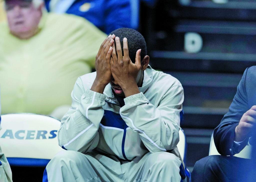 Sophomore guard Zay Jackson sits head in hands during a men’s basketball game against Brescia earlier in the season. He has been benched indefinitely after he was indicted for striking two individuals with his car in a Walmart parking lot. || Samuel T. Hays/The News