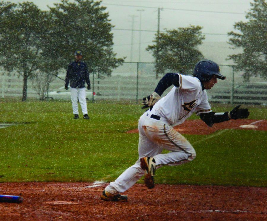 Sophomore Rick Linton runs to first base during Fridays 15-5 loss. Linton recorded one of the Breds eight hits of the game.