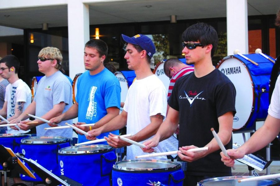Emily Clark/The News
Members of the Racer Band drumline entertain students passing by outside of Price Doyle Fine Arts Center. 