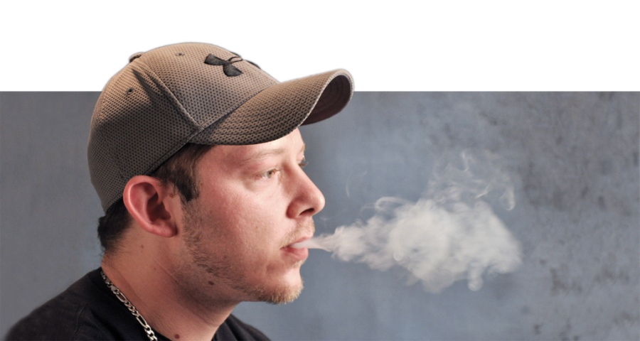 Photo illustration by Ana Bundy and Lori Allen/The News
Toby Monts, freshman from Murray, puffs on an e-cigarette indoors. Monts only smokes e-cigarettes occasionally because he said they do not have the same effect as a regular cigarette. 