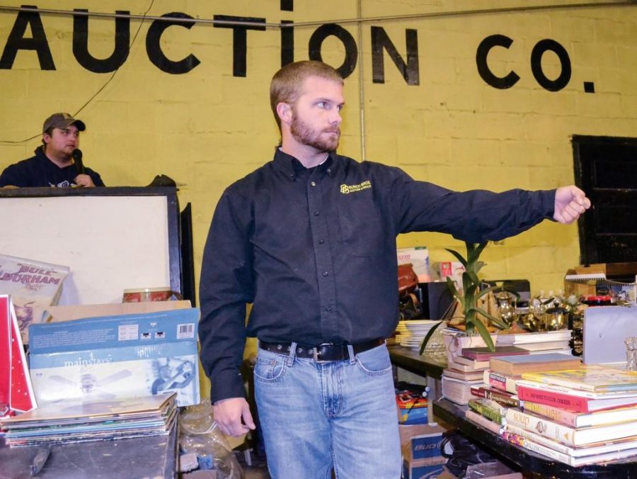 Megan Godby/The News
Joe Bunch, senior from Wingo, Ky., auctions off items for his family’s auction company.