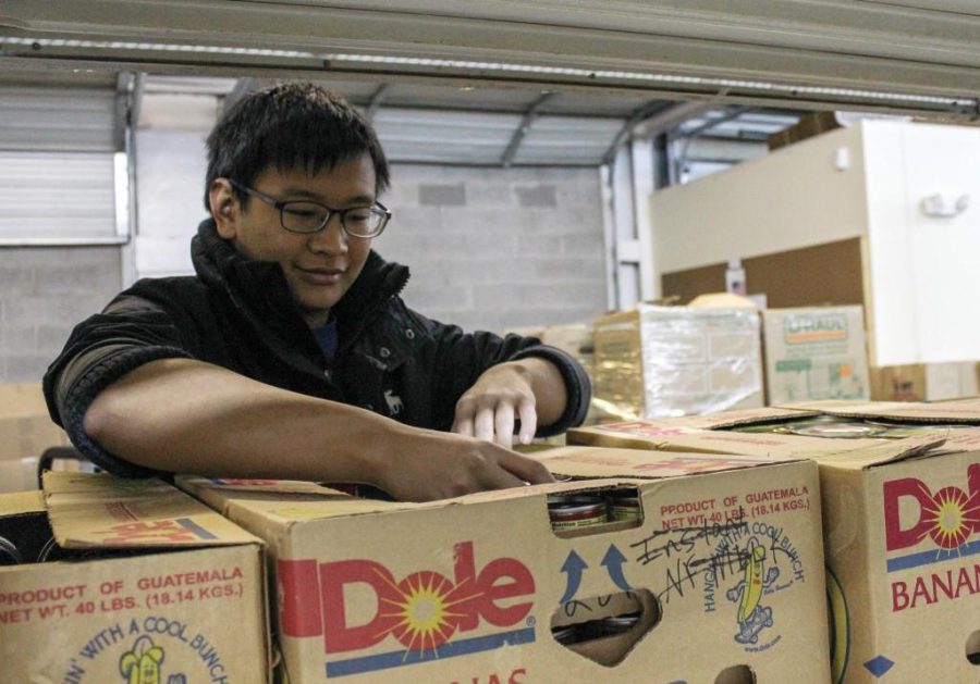 Kate Russell/The News
Blake Lin, a sophomore from China, helps load boxes at Need Line for the move to its new building.