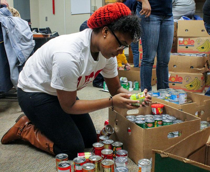 Jenny Rohl/The News
Delta Sigma Theta member, Jovon Richmond, graduate student from Louisville, Ky., helps unload canned goods Monday during the Martin Luther King Jr. Day of Service. 