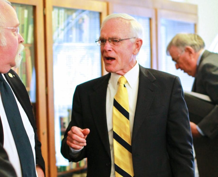 Fumi Nakamura/The News
President Tim Miller talks to Staff Regent Phil Schooley after Wednesday’s board meeting.