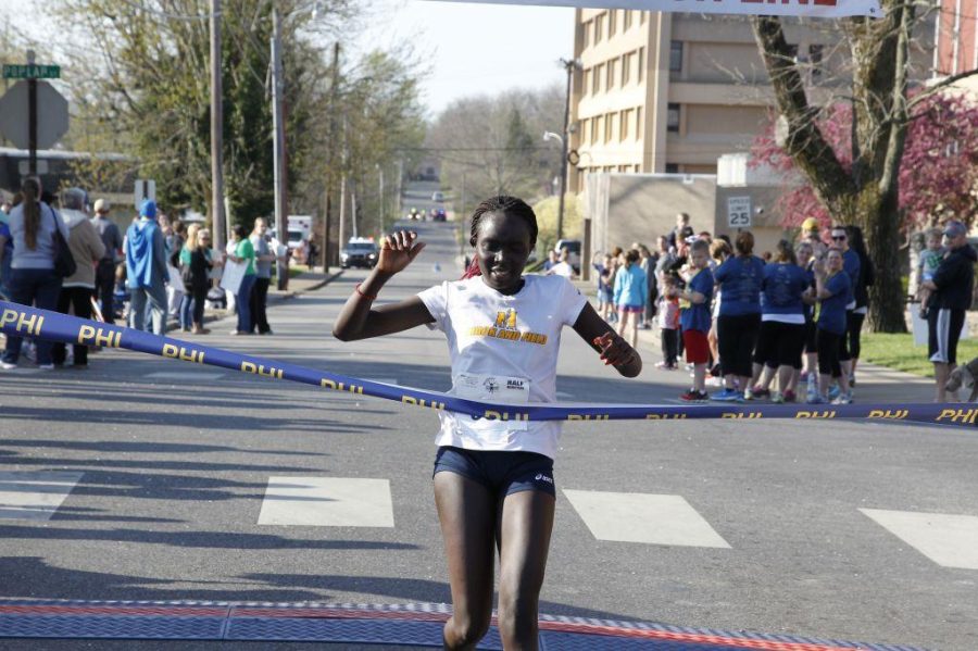 Photo courtesy of Filmburners Photo Club
Carolyne Tanui, graduate student from Murray,  crosses the finish line.