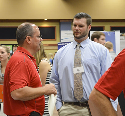 Hannah Fowl/The News
Drew Kelley (right), senior from Thompson’s Station, Tenn., speaks with a potential employer at the Career Fair.