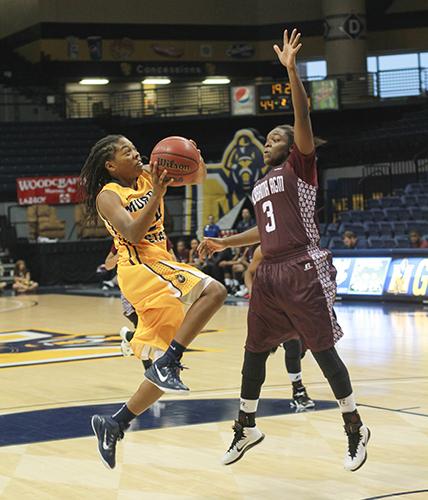 Jenny Rohl/The News
Freshman point guard, Olivia Cunningham shooting against an Alabama A&M Bulldog point guard.