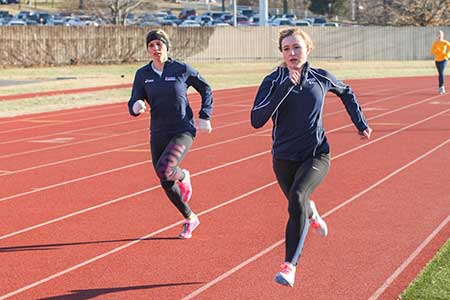 Haley Hays/The News
Junior distance runner Emma Gilmore and senior mid-distance runner Brittany Bohn run around the track during practice.