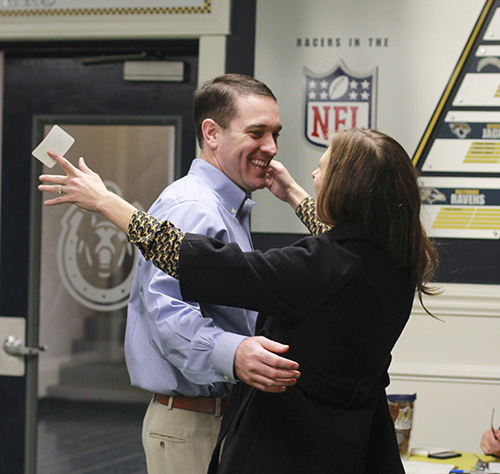 Jenny Rohl/The News
Head Coach Mitch Stewart embraces his wife at a signing day meet-and-greet Feb. 4 at the Racer Room in Roy Stewart Stadium.