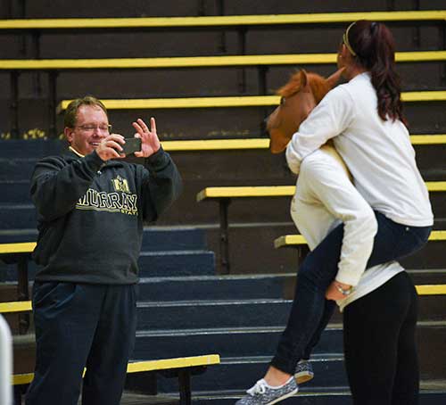 Kory Savage/The News
President Bob Davies photographs two students during the OVC volleyball tournament championship game at Racer Arena Nov. 12.