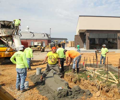 Haley Hays/The News
Construction workers work outside of Panera Bread, which is predicted to open in about a month.