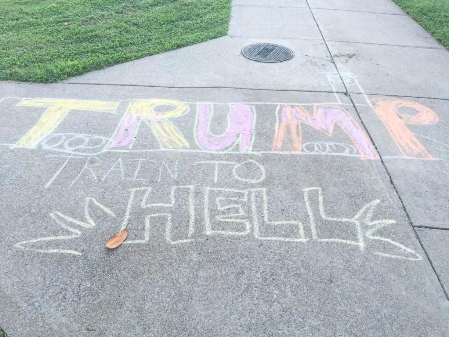 Students chalk campus expressing opinion of presidential candidates