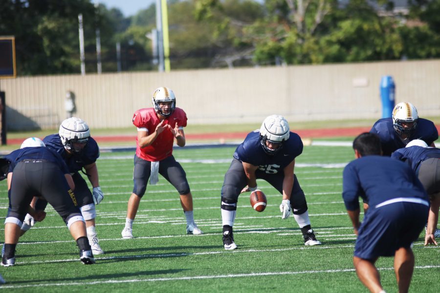Senior+quarterback+Shuler+Bentley+takes+a+snap+during+Mondays+practice.+Bentley+and+senior+Drew+Anderson+are+both+competing+for+the+starting+role+at+quarterback.+%28Photo+by+Blake+Sandlin%2FTheNews%29