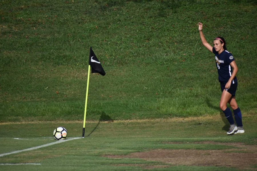 Sophomore midfielder Kayla Travis signals for a corner kick. (Photo by Gage Johnson/TheNews)
