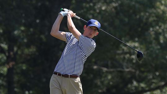 Senior Austin Knight watches his ball sail down the golf course. (Photo courtesy of Dave Winder/Racer Athletics)