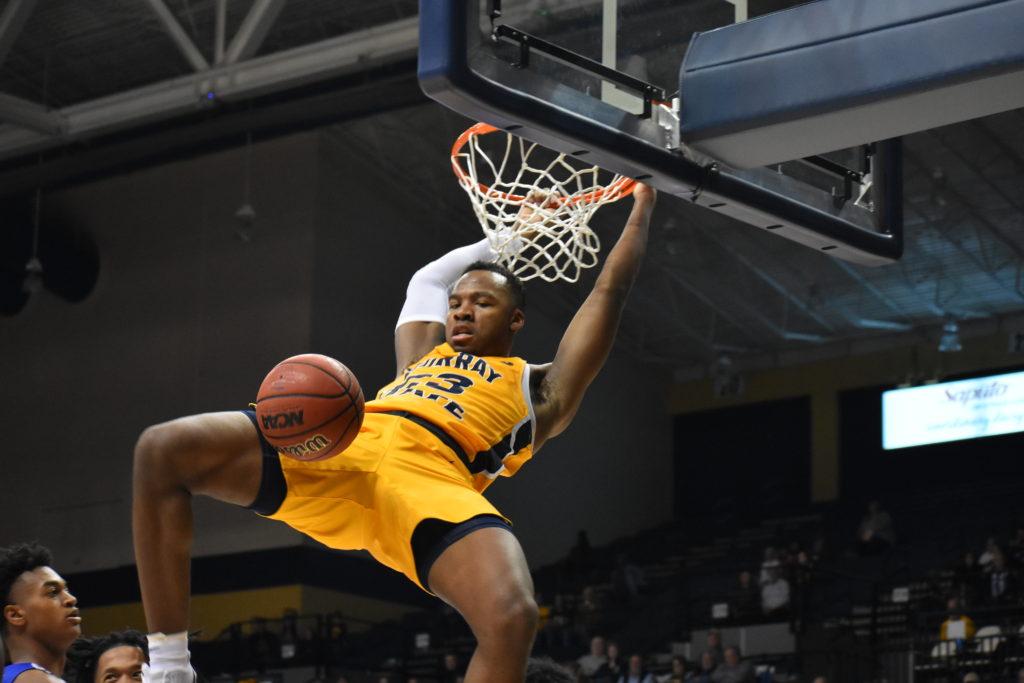 Sophomore forward KJ Williams hangs on the rim after a monstrous slam dunk. (Photo by Gage Johnson/TheNews)