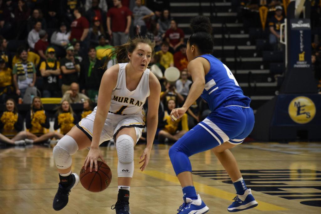 Sophomore guard Raegan Blackburn dribbles between the legs to try and shake the Tennessee State defender. (Photo by Gage Johnson/TheNews)
