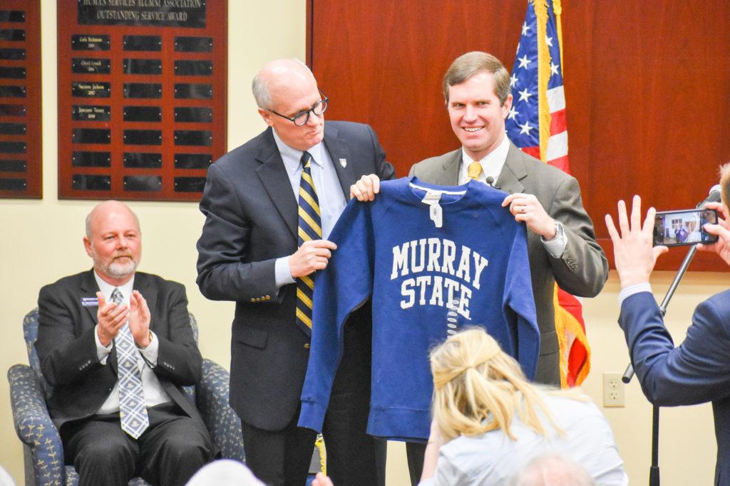 President Bob Jackson presents Gov. Andy Beshear with a Murray State sweatshirt. (Paige Bold/The News)