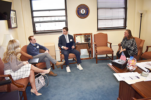 Students Trey Book, Jackson Hogg and Hannah Daab speak with Rep. Suzanne Miles. (Addison Watson/The News)