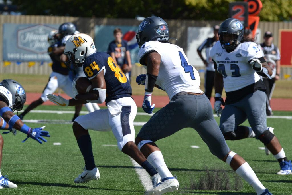 Junior running back Jared McCray attempts to evade the EIU defenders in a 2019 regular season game. (Photo by Lauren Morgan/TheNews)
