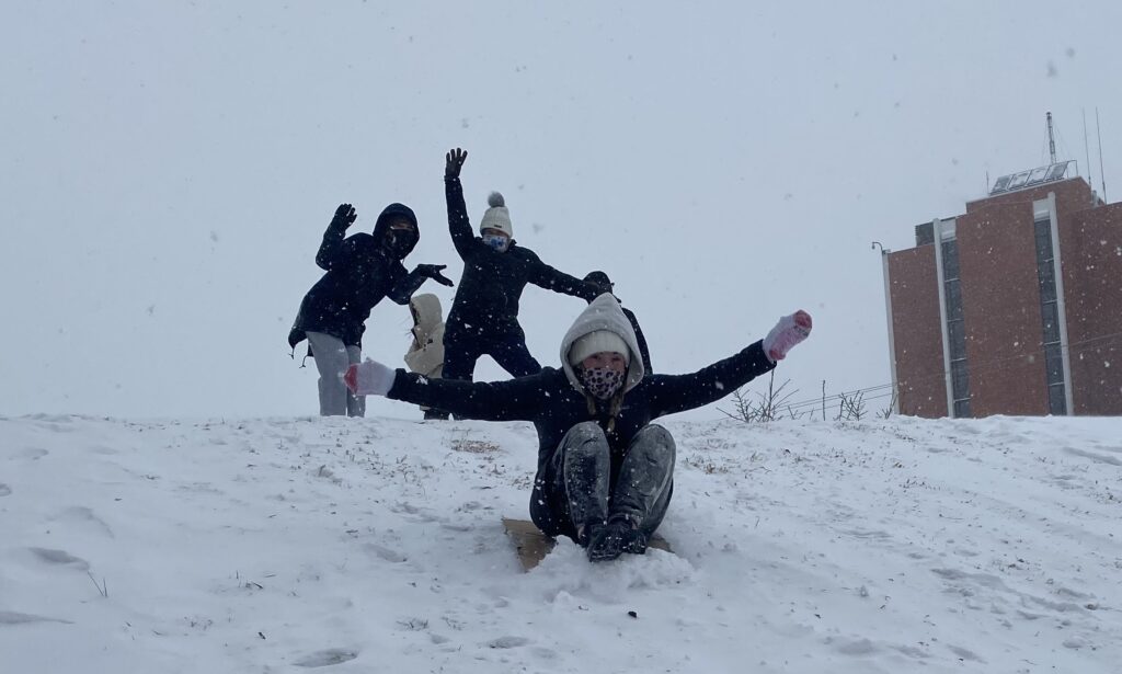 Students sledding down the hill in front of the Curris Center. (Dionte Berry/The News)