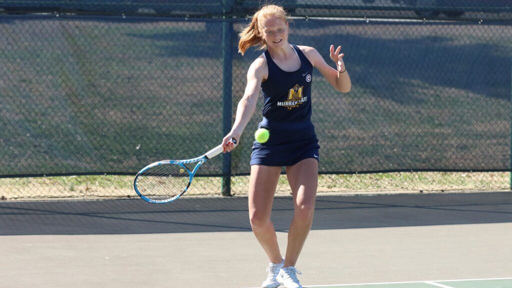 Freshman Sarah Bureau takes swing to return the ball during a weekend of conference competition. (Photo courtesy of Dan Hasko/Racer Athletics)