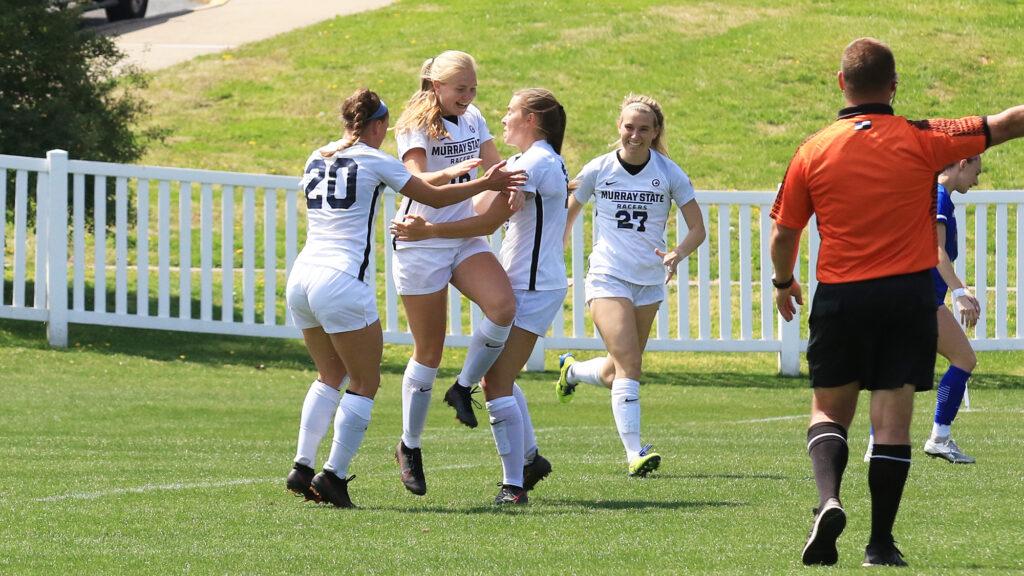 The Racers celebrate with freshman forward Chloe Barnthouse after her hat trick against EIU. (Photo courtesy of Justin Ertl/Racer Athletics)