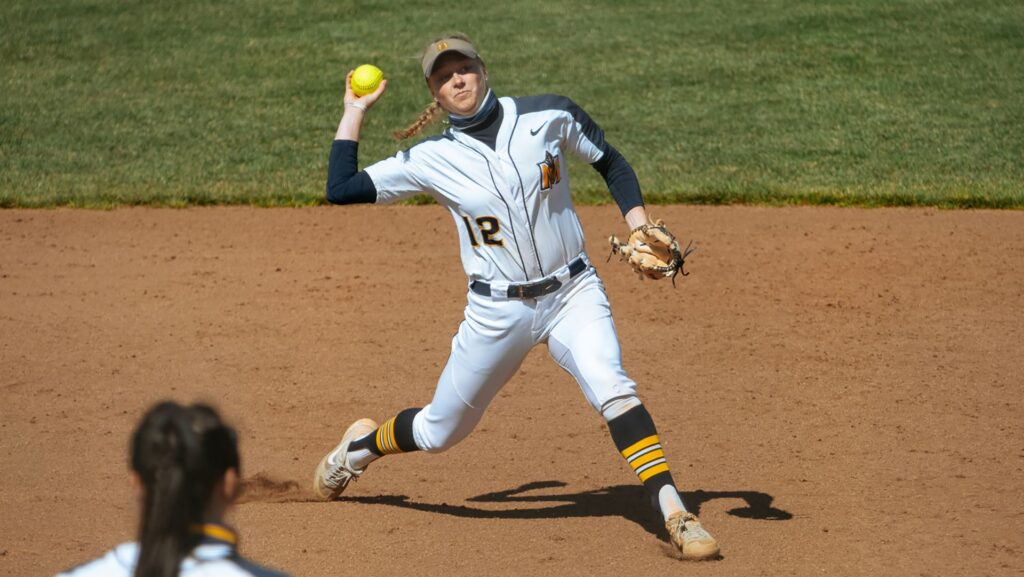 Senior Sierra Gilmore plants her feet to make a throw to first. (Photo courtesy of Piper Cassetto)