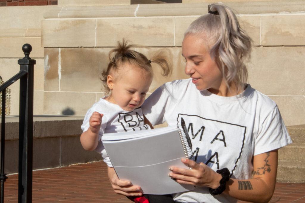 Makenna Crowley and her 15-month-old daughter Charleigh have adjusted well to online class instruction. (Levi Brandenburg/The News)