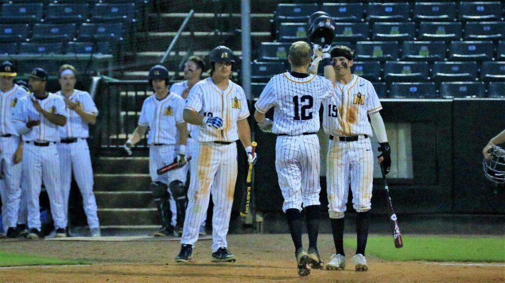 Senior second baseman Jordan Cozarts teammates greet him as he crosses the plate after hitting a home run against Morehead State. (Photo courtesy of Racer Athletics)