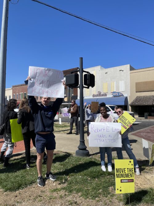 Students in College Democrats protest the location of the Robert E. Lee monument, holding signs above that read, ‘Honk to remove Robert’ and ‘Robert E. Lee was a traitor (Photo courtesy of Libby Gerdes).
