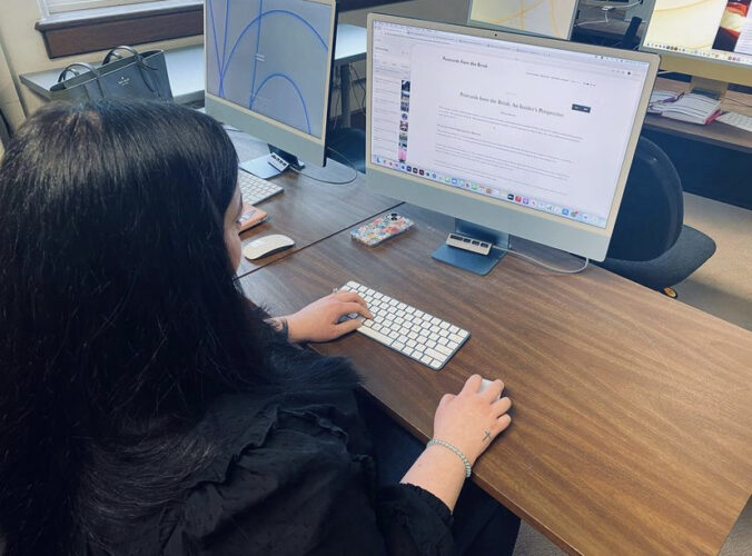A student posts the first blog post on the “Postcards From The Brink” website (Photo courtesy of Instagram).