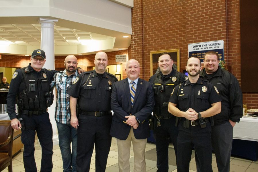 Retired Police Chief Jeff Gentry and Interim Chief Ryan Orr stand with a group of their officers at his retirement ceremony (Rebeca Chiodini Mertins/The News). 