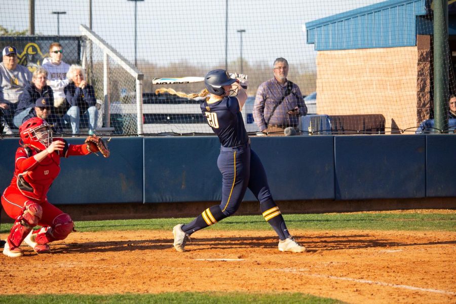 Freshman infielder Ailey Schyck hits a double to bring freshman outfielder Jadyn Thompson home to score against the Austin Peay Governors on Wednesday, March 29. Photo by Rebeca Mertins Chiodini/The News.