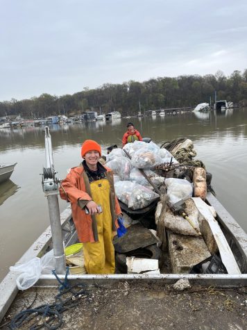 Nonprofit Leadership Studies major Zach McCarver (front) cleaning on the Mississippi River. (Photo courtesy of Mike Gowen)