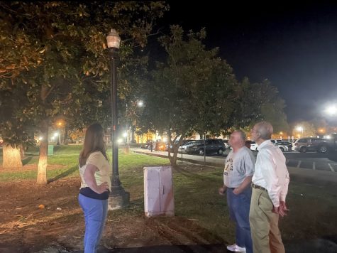 Joanne Gunns, Jamie Miller and Don Robertson examine the lights during the April safety walk. (Jill Smith/The News)