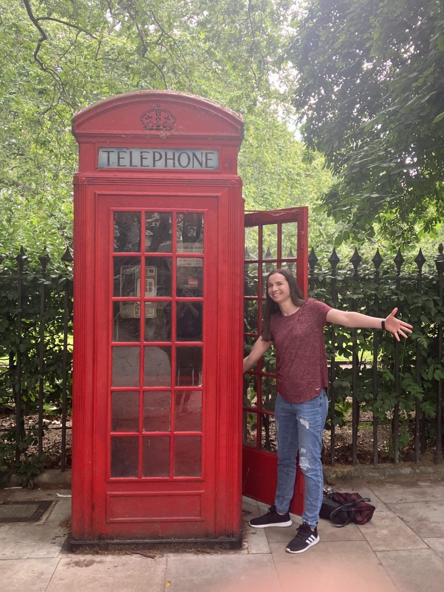 Ava Chuppe posing beside a telephone booth outside of Russell Square Gardens in London, UK. 