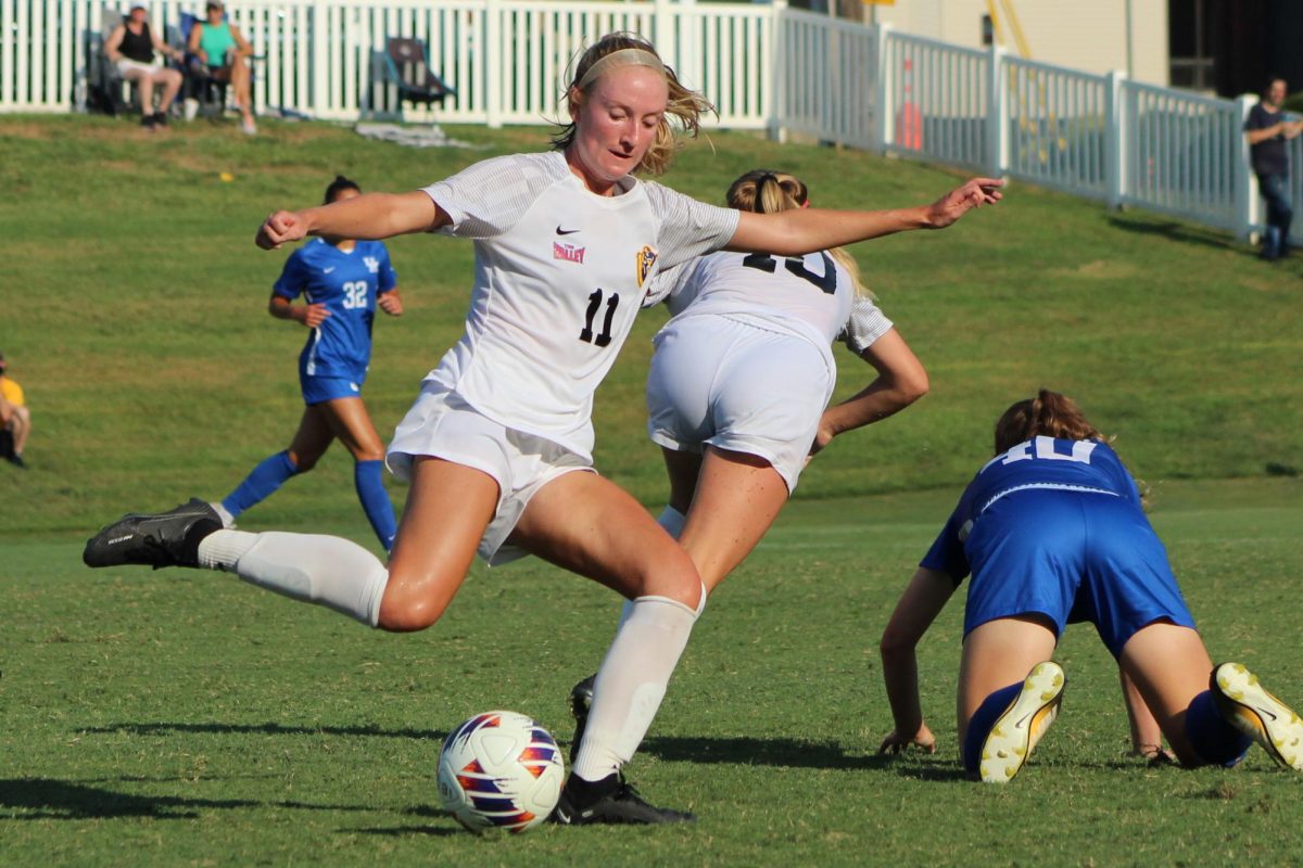 Midfielder Hailey Cole goes to clear the ball from Racer territory. 
