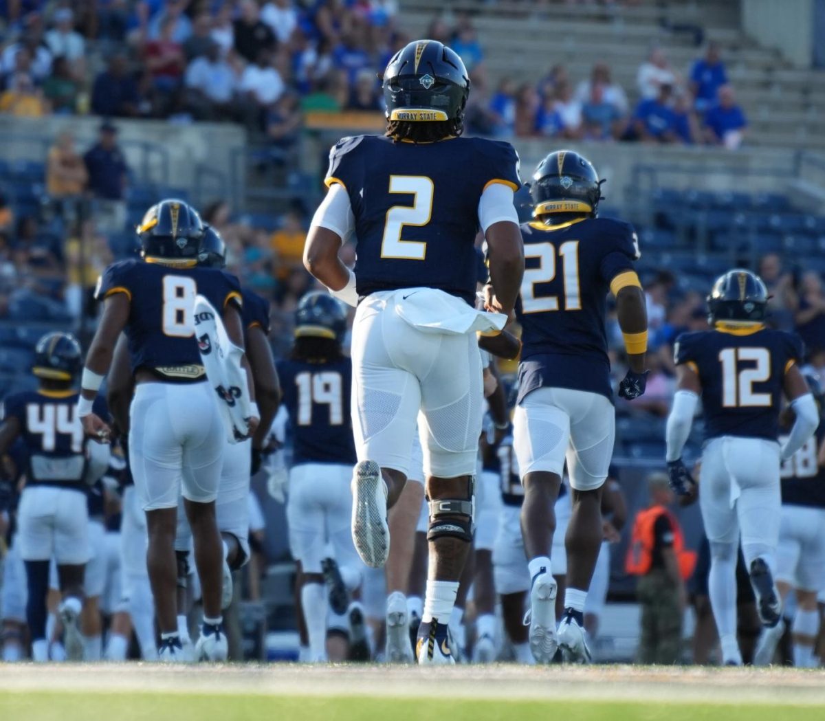 Sophomore quarterback DJ Williams (center) runs out for the Racers first game against Presbyterian College.