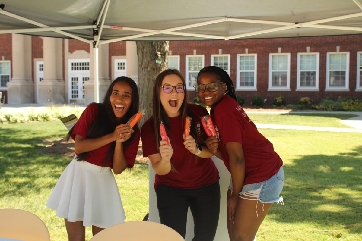 Members of Clark's RCC pose with popsicles they handed out at the Residental College Fair.