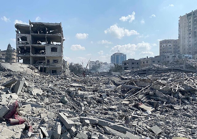 Palestinians inspect the damage following an Israeli airstrike in Gaza City on Oct. 9, 2023.