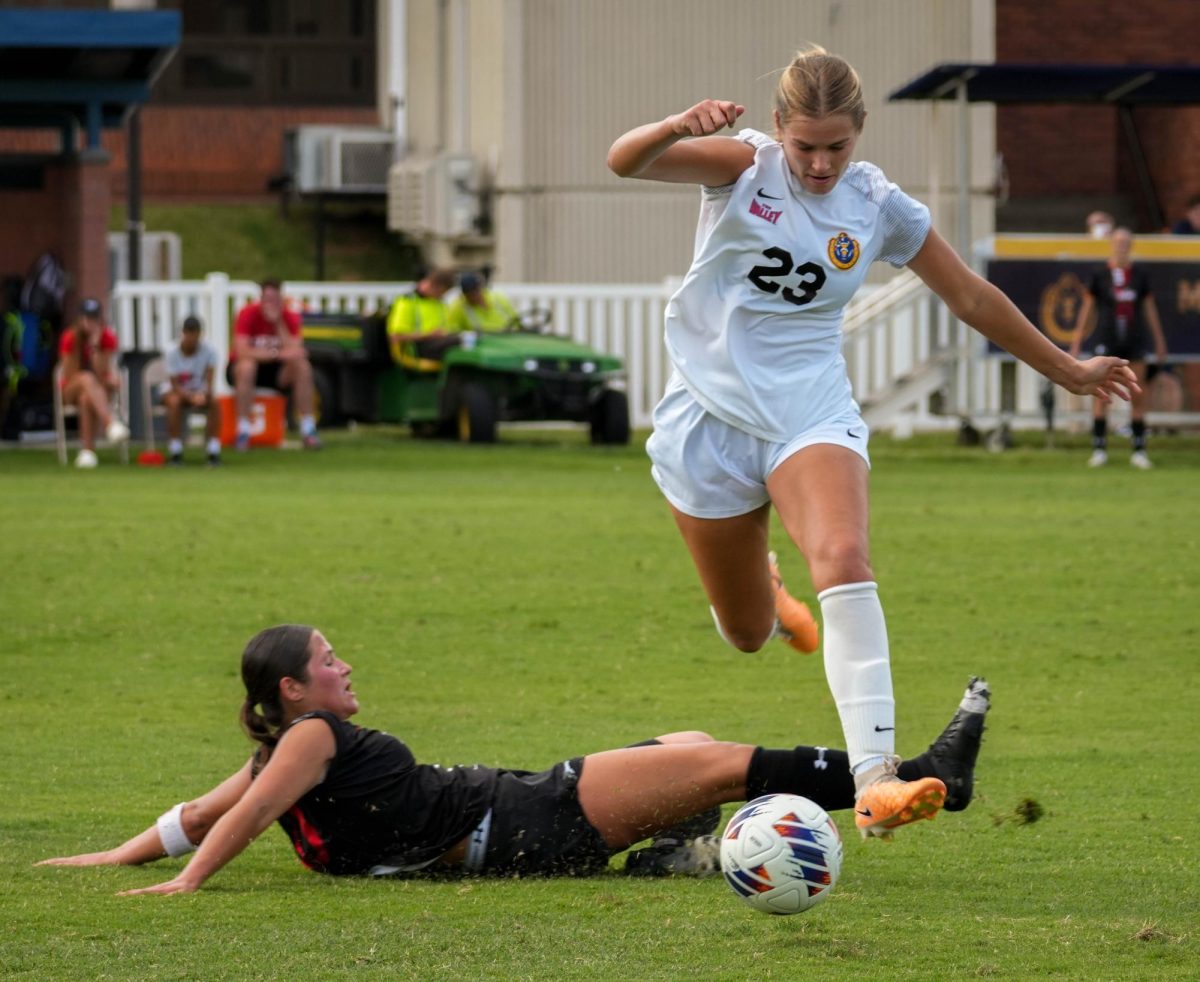 Tori Schrimpf jumps over a SEMO defender. (Sept. 10)