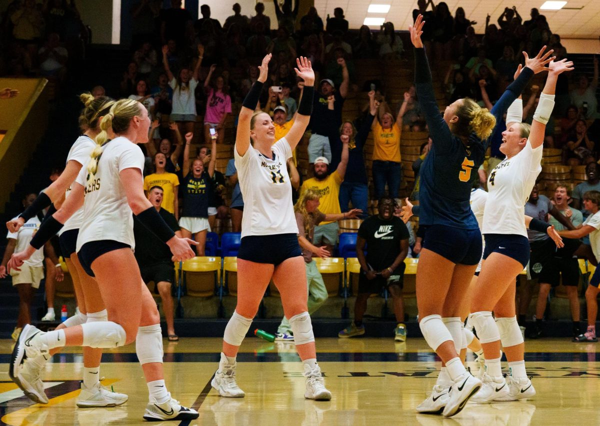 The volleyball team celebrates a won point. (Sept. 22)