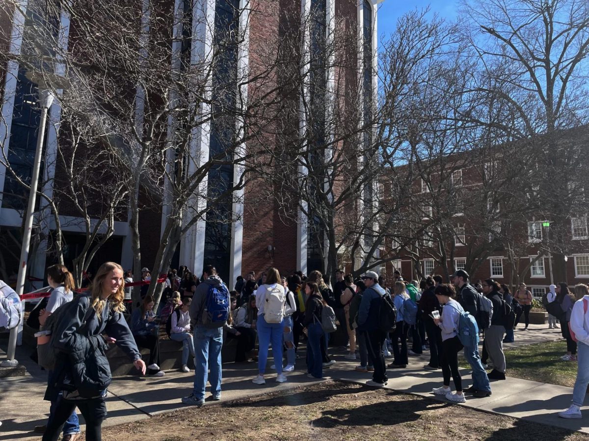 Students stand outside Faculty Hall waiting for the all-clear from the fire department. 