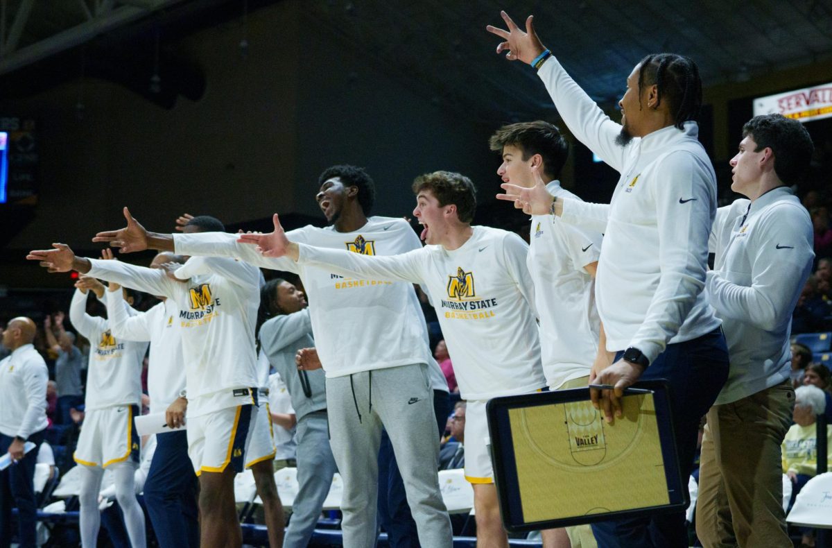 The Murray State bench celebrates a made three pointer.