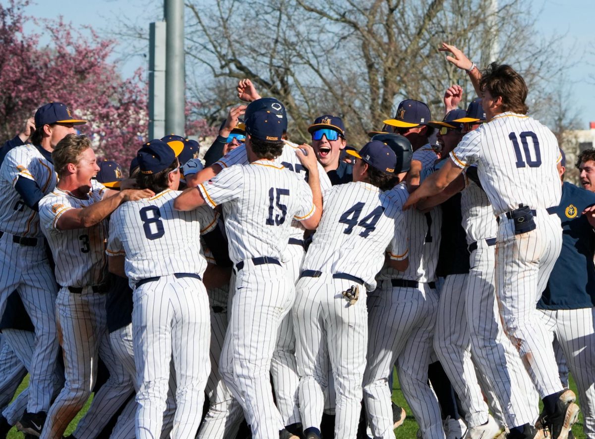 The team surrounds graduate infielder Taylor Howell to celebrate his walk-off hoemrun.