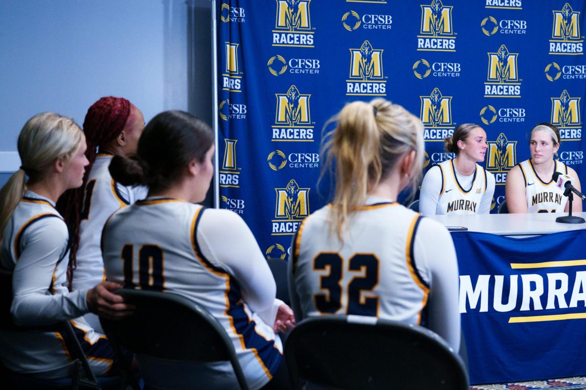 Seniors Hannah McKay and Katelyn Young are interviewed at the post game press conference as seniors Charlee Settle, Lucia Operto, Cayson Conner, and Bria Sanders-Woods watch. 