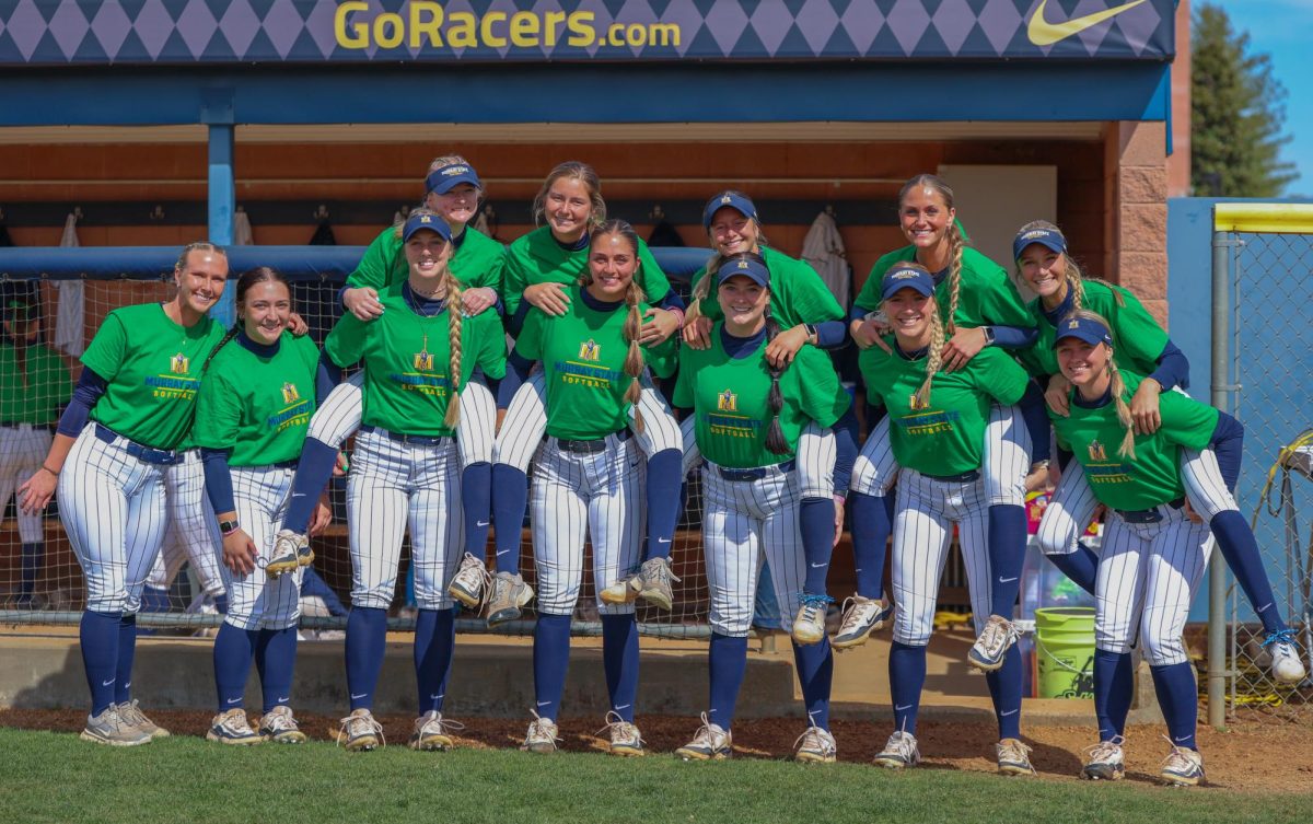 The team in front of the dugout before the game. The team wore green on Sunday for St. Patricks day. 