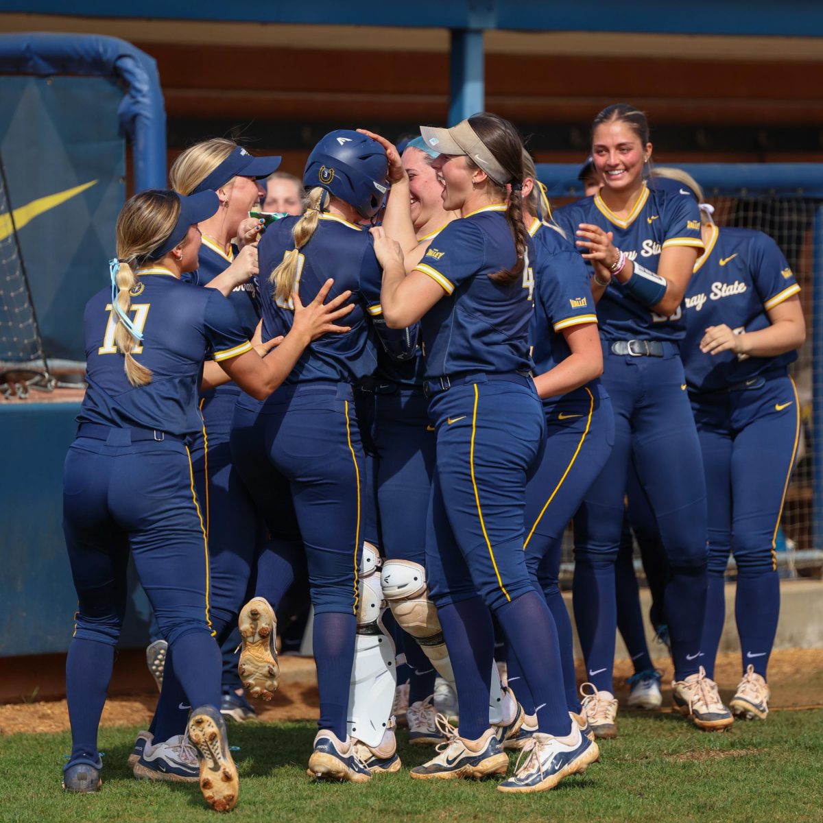 The team celebrates with freshman infielder Parker Holcombe after an in the park home run. 